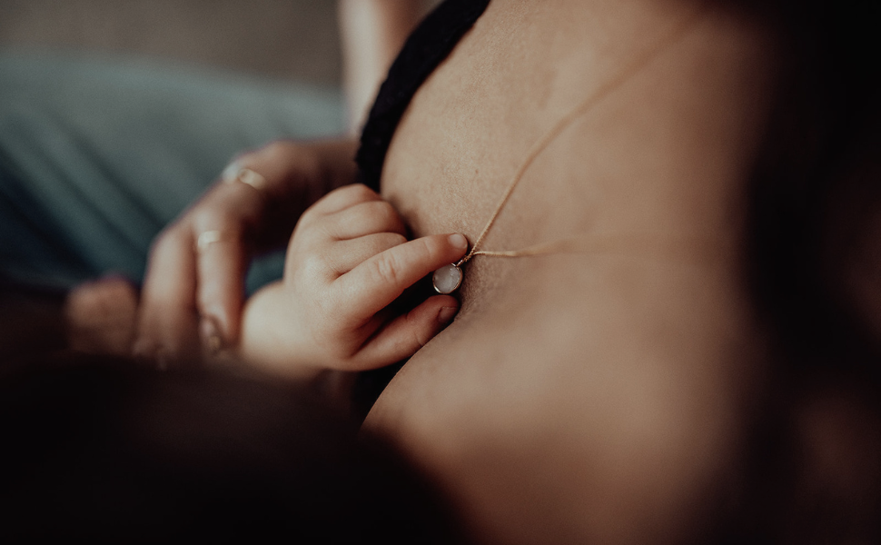 Close-up of a person wearing a black bra with a blurred background