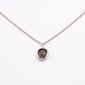 Necklace with a pendant featuring a rough diamond on a white background